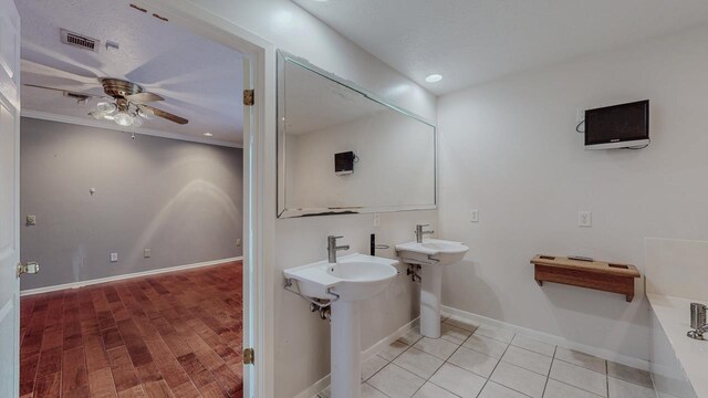1995 Sams Way, Beaumont, TX 77706 - full bath with ceiling fan, baseboards, wood finished floors, a bathtub, and a sink