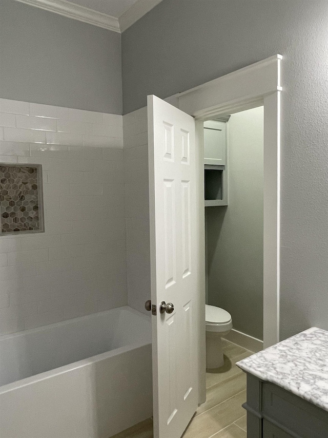 full bath featuring toilet, shower / bath combination, crown molding, and vanity