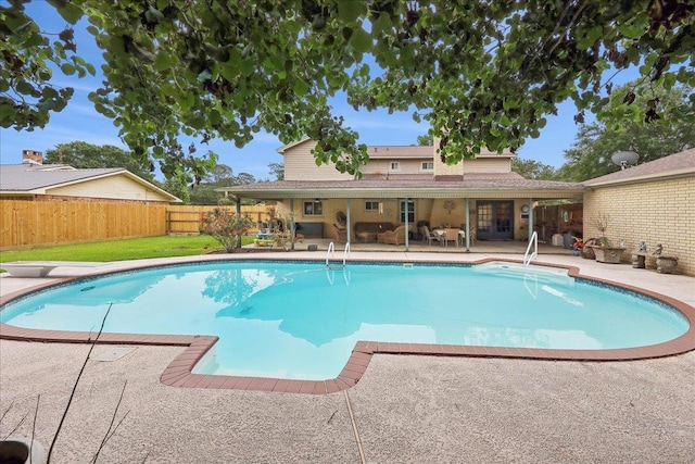 view of pool with a fenced in pool, a diving board, a fenced backyard, and a patio area