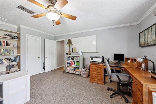 carpeted office with visible vents, a ceiling fan, a textured ceiling, and crown molding