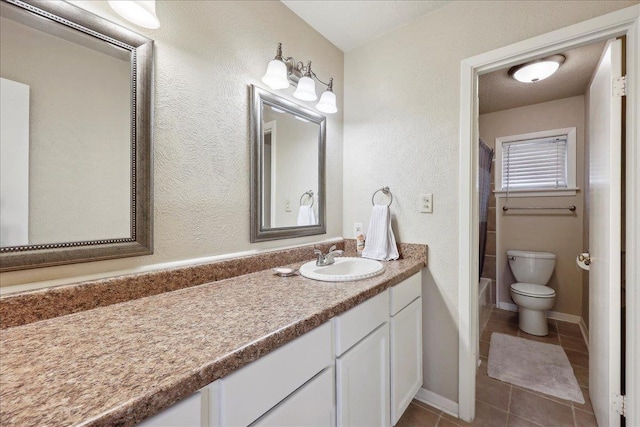 full bath with tile patterned flooring, baseboards, toilet, and vanity