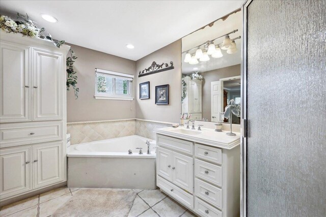 2414 Goodwin Ct, Port Neches, TX 77651 - bathroom featuring tile patterned floors, vanity, and a bath