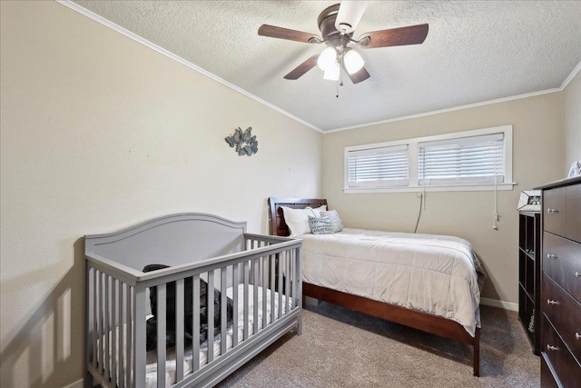 bedroom featuring ceiling fan, ornamental molding, carpet flooring, and a textured ceiling