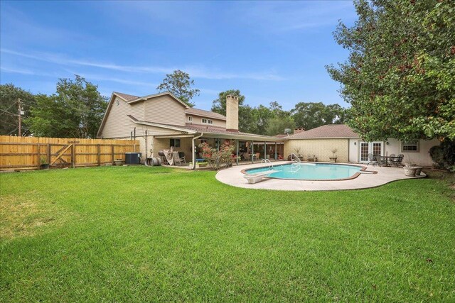 2414 Goodwin Ct, Port Neches, TX 77651 - view of pool with french doors, a lawn, a patio area, cooling unit, and a fenced backyard