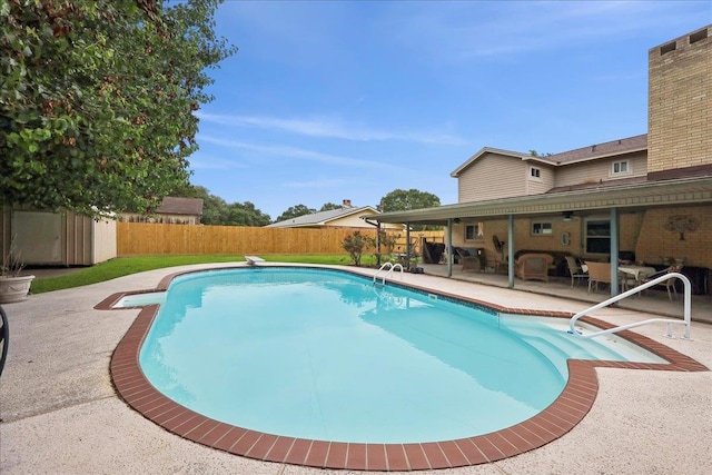 view of swimming pool with a fenced backyard, a fenced in pool, and a patio area