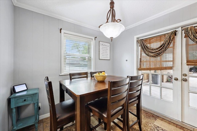 dining area featuring crown molding and french doors