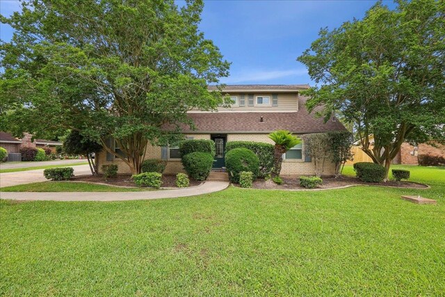 2414 Goodwin Ct, Port Neches, TX 77651 - view of front facade with brick siding and a front lawn