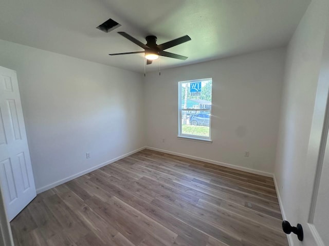 1117 W Dr, Port Neches, TX 77651 - unfurnished room with a ceiling fan, wood finished floors, and baseboards