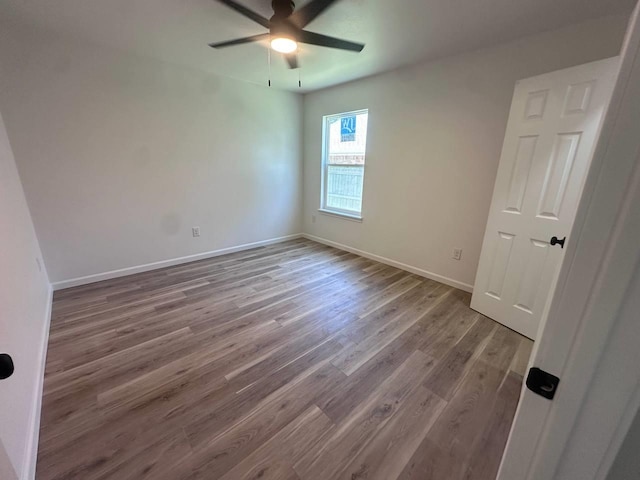 1117 W Dr, Port Neches, TX 77651 - empty room with wood finished floors, ceiling fan, and baseboards