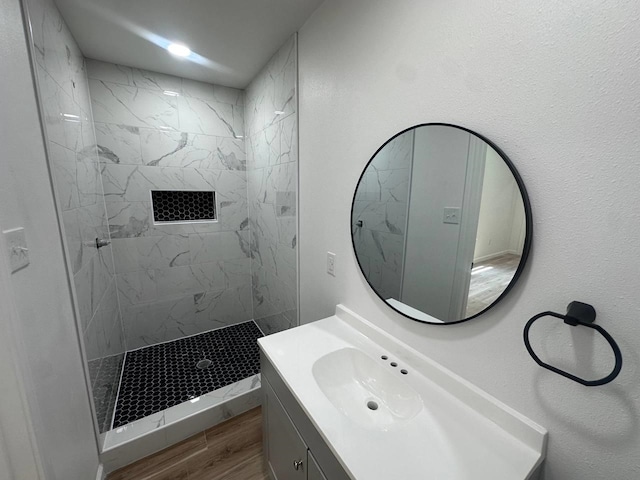 1117 W Dr, Port Neches, TX 77651 - full bathroom featuring vanity, tiled shower, and wood finished floors