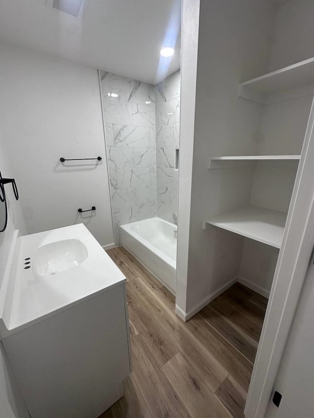 1117 W Dr, Port Neches, TX 77651 - full bathroom with wood finished floors, vanity, shower / tub combination, and baseboards