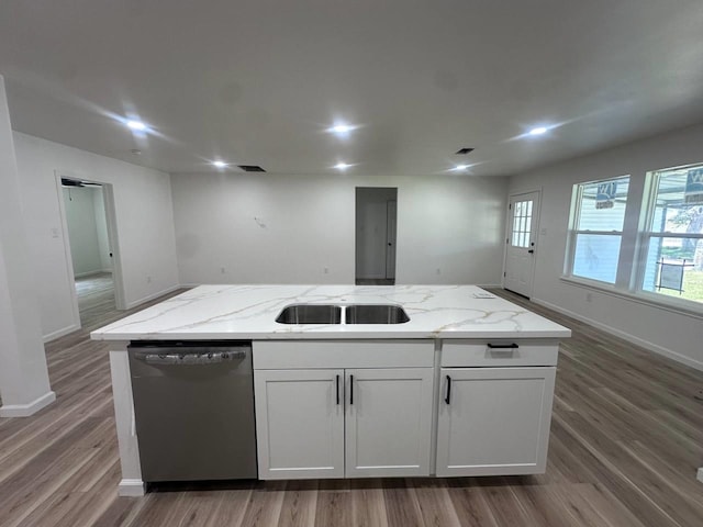 1117 W Dr, Port Neches, TX 77651 - kitchen featuring dishwasher, wood finished floors, an island with sink, light stone counters, and baseboards