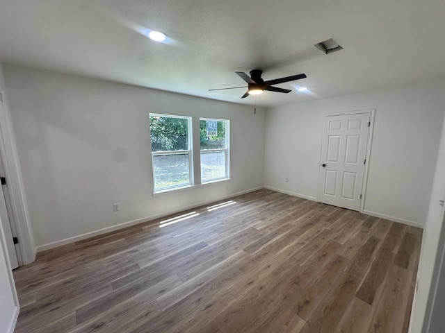 1117 W Dr, Port Neches, TX 77651 - unfurnished bedroom with wood finished floors, baseboards, and a ceiling fan