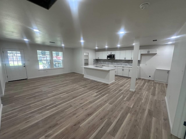 1117 W Dr, Port Neches, TX 77651 - unfurnished living room featuring light wood-type flooring and baseboards