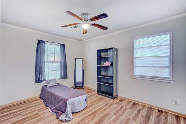 bedroom with light hardwood / wood-style floors, ceiling fan, and ornamental molding