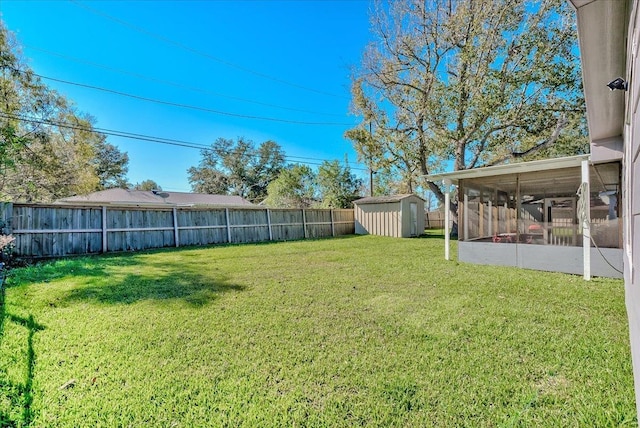 view of yard with a sunroom and a shed