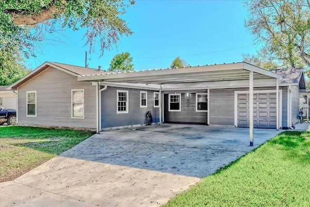 rear view of property featuring a lawn and a carport