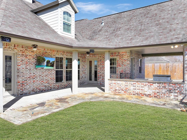 exterior space featuring a patio, brick siding, area for grilling, and a lawn