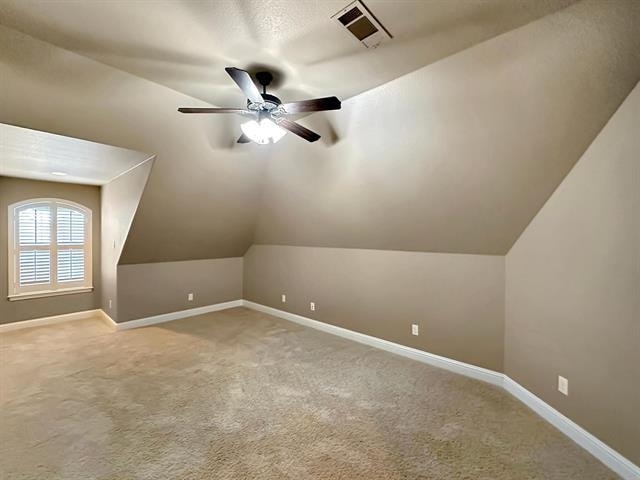 bonus room with visible vents, a ceiling fan, vaulted ceiling, and carpet floors
