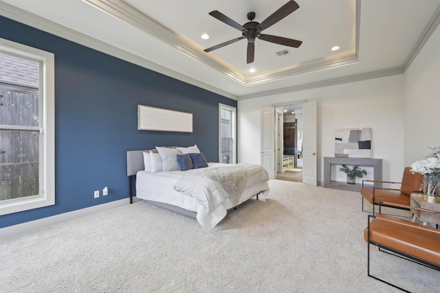 bedroom with ornamental molding, recessed lighting, a tray ceiling, and carpet floors