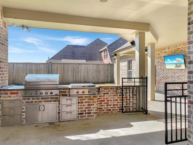 view of patio / terrace with a grill, fence, and area for grilling