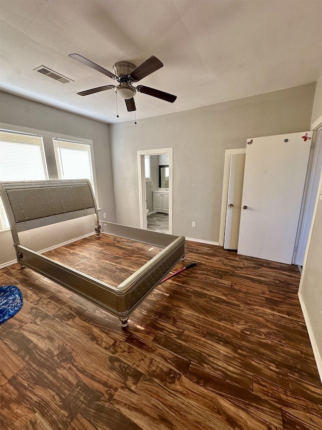 unfurnished bedroom with connected bathroom, ceiling fan, and dark hardwood / wood-style floors