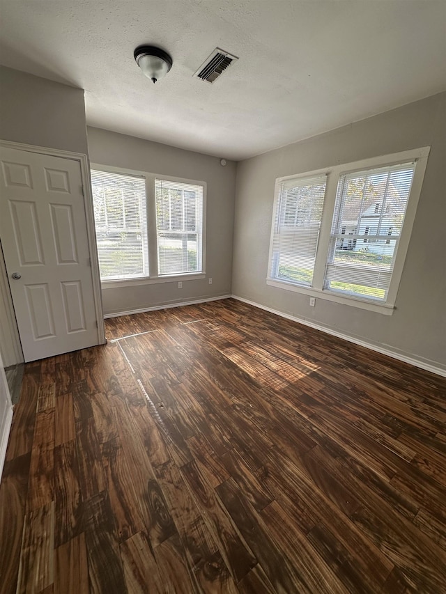 empty room with dark hardwood / wood-style floors