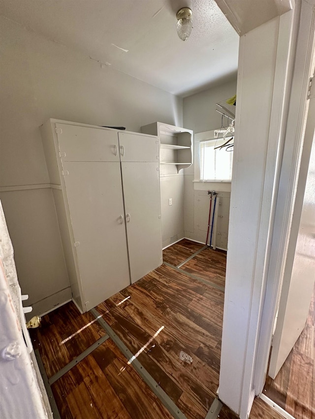 laundry area with dark hardwood / wood-style floors