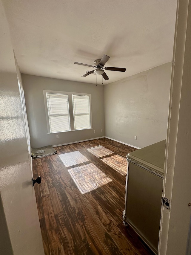 empty room featuring dark hardwood / wood-style floors and ceiling fan