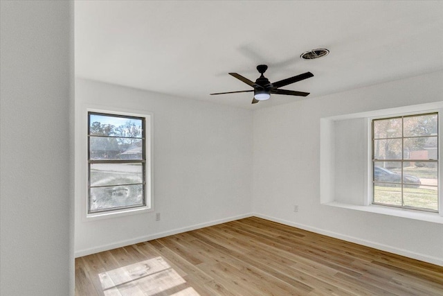 spare room with light hardwood / wood-style flooring and ceiling fan