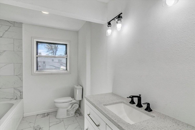 bathroom with a tub, vanity, and toilet