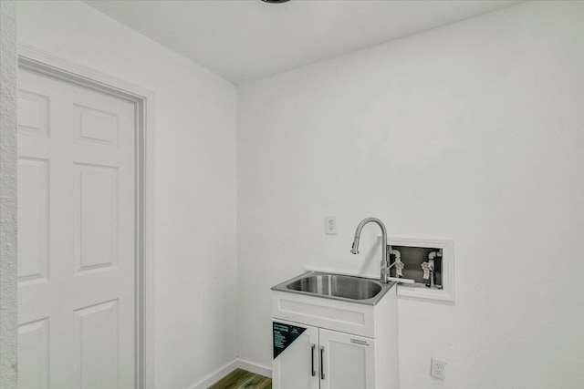 laundry area featuring cabinets, washer hookup, hardwood / wood-style flooring, and sink