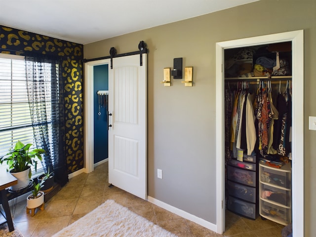 interior space with a barn door and a closet