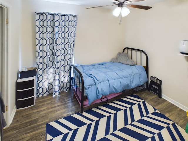 bedroom featuring ceiling fan and dark hardwood / wood-style floors