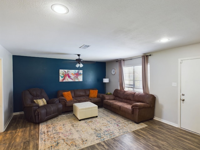 living room with ceiling fan, wood-type flooring, and a textured ceiling