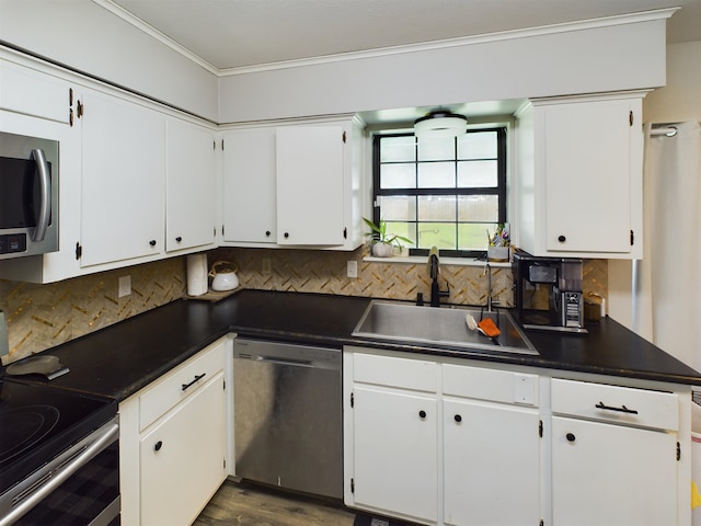 kitchen with decorative backsplash, white cabinetry, sink, and stainless steel appliances