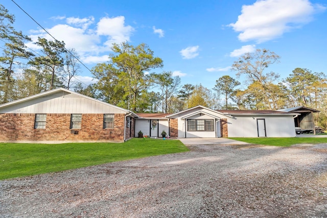 165 Trahan Rd, Lumberton, TX 77657 - view of front of home with gravel driveway, a front lawn, and brick siding