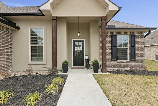 view of exterior entry featuring a lawn