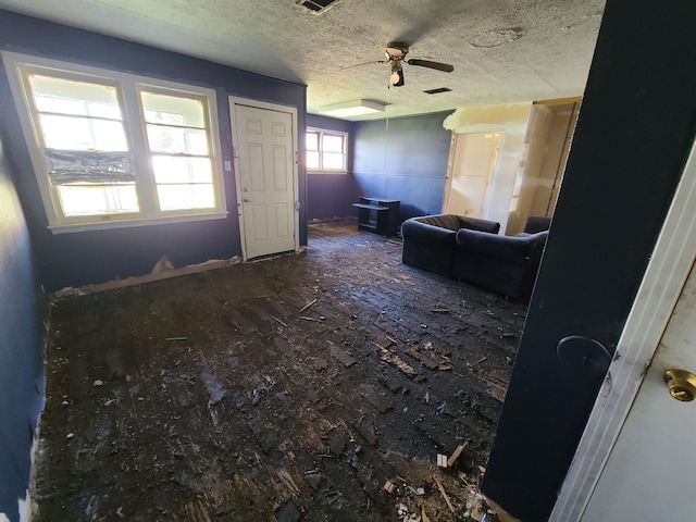 interior space featuring ceiling fan and a textured ceiling