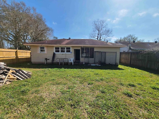 rear view of house featuring a lawn