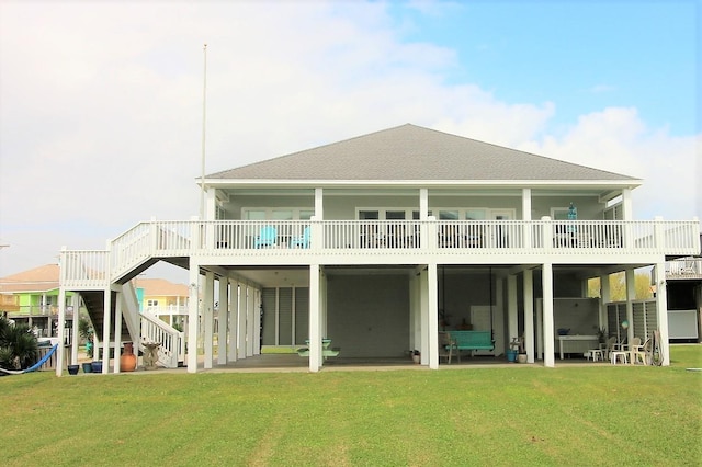 rear view of house featuring a yard