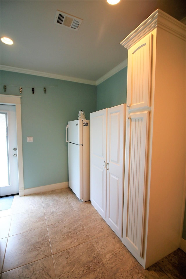 kitchen featuring white refrigerator and ornamental molding