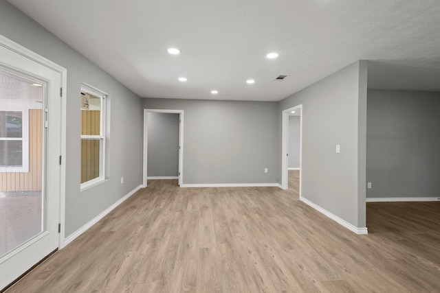 6425 Adams Blvd, Groves, TX 77619 - spare room featuring light wood-style floors and recessed lighting