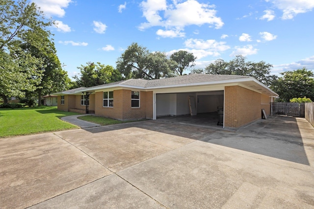 6425 Adams Blvd, Groves, TX 77619 - ranch-style house featuring driveway, brick siding, and an attached garage