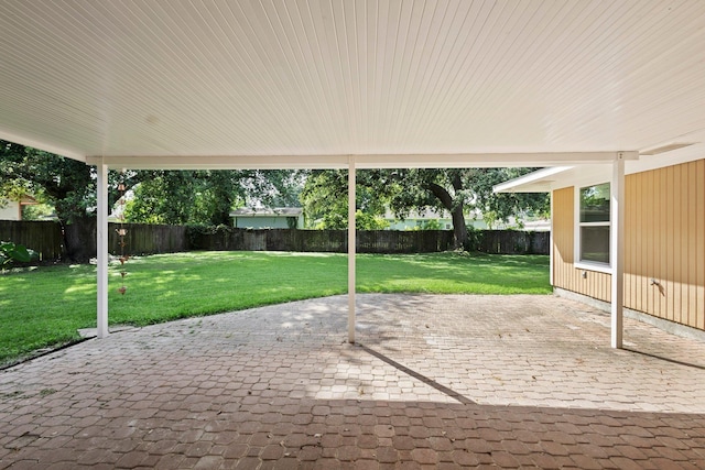 6425 Adams Blvd, Groves, TX 77619 - fenced backyard featuring a patio