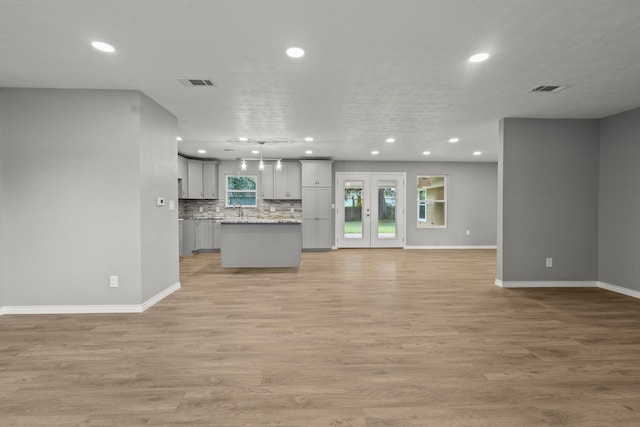 6425 Adams Blvd, Groves, TX 77619 - unfurnished living room with recessed lighting and light wood-style floors