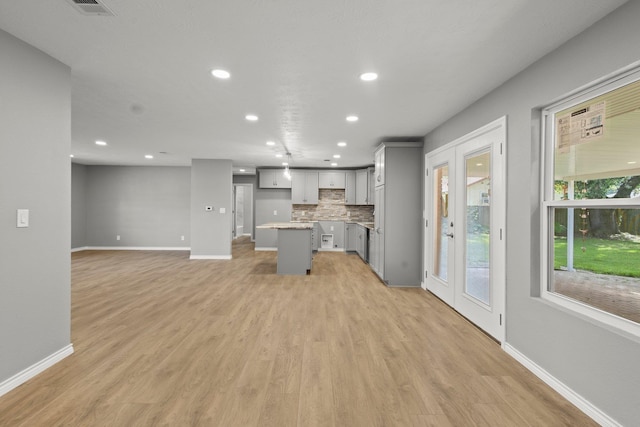 6425 Adams Blvd, Groves, TX 77619 - unfurnished living room with recessed lighting and light wood-style flooring
