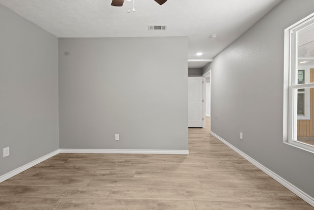 6425 Adams Blvd, Groves, TX 77619 - unfurnished room featuring a ceiling fan and light wood-style floors