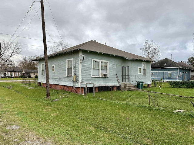 back of house with a lawn and cooling unit