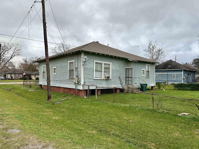 back of house with a lawn and cooling unit